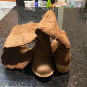 Tall brown knee boots .